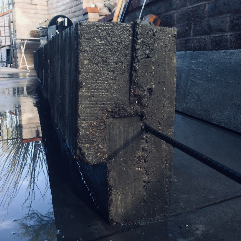Concrete Bench, wet with other masonry patterns surrounding.